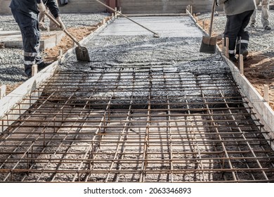 Pouring cement or concrete with a concrete mixer truck, construction site with a reinforced grillage foundation, start of construction of a production workshop - Shutterstock ID 2063346893