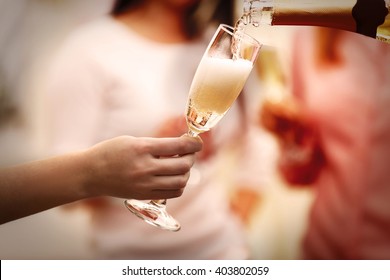 Pouring champagne into glass at hen-party, close up - Powered by Shutterstock