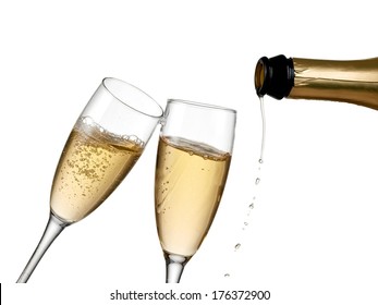 Pouring champagne into two glasses.