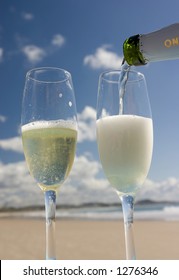 Pouring Champagne On The Beach