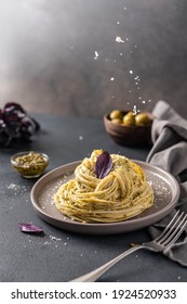 Pouring Cheese On Pasta With Pesto Sauce. Mediterranean Cuisine. Side View