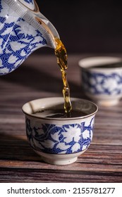 Pouring Chinese Tea In Teacup From Teapot