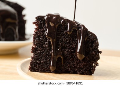 Pouring Chocolate Sauce On Piece Of Chocolate Cake