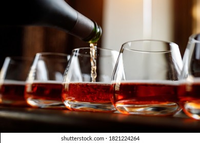 Pouring Cider Into Glass From Bottle