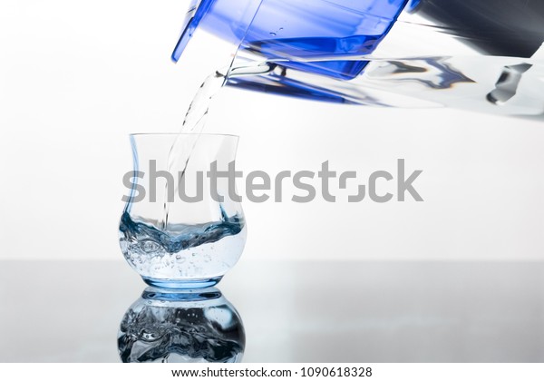 Pouring clean water\
from water filter\
pitcher