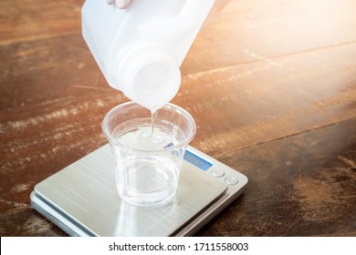 Pouring Clear Resin To Plastic Cup For Measuring Before Make Res