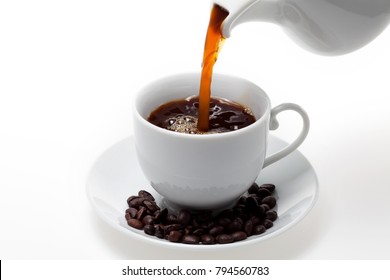 Pouring Coffee Into White Coffee Cup And Beans On White Background