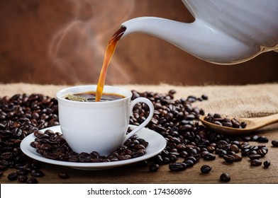 Pouring Coffee Surrounded By Coffee Beans