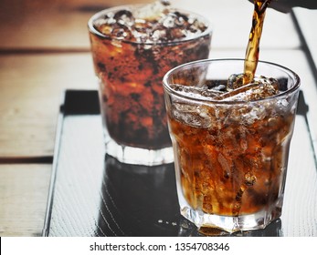 Pouring cola drink on glass
