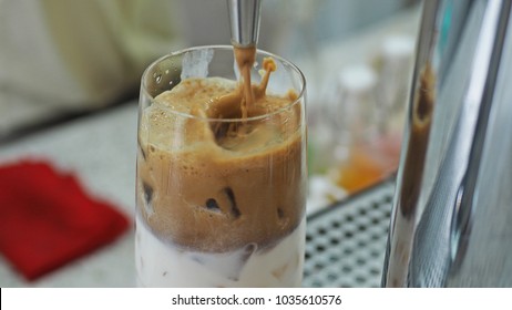 Pouring Cold Brew Espresso Into Milk And Ice For Refreshing Summer Drink Concept! Iced Latte Fresh From Coffee Tap Counter. (close Up, Selective Focus, Blurred Space For Text)