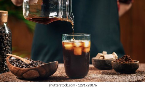 Pouring Cold Brew Iced Coffee In Glass Cup With Ice Cubes