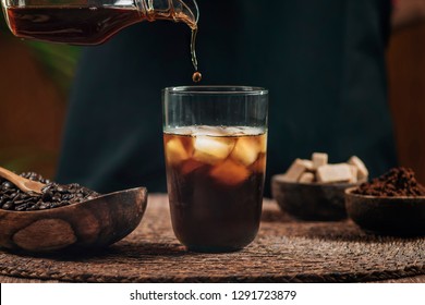 Pouring Cold Brew Iced Coffee In Glass Cup With Ice Cubes