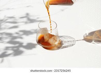 Pouring Cold Drink on ice in the Sun. Cold brew Ice Summer. Summertime drink. Sunny Day Drink. Cold Tea. Iced Tea. Cold Coffee. Ice Coffee - Powered by Shutterstock