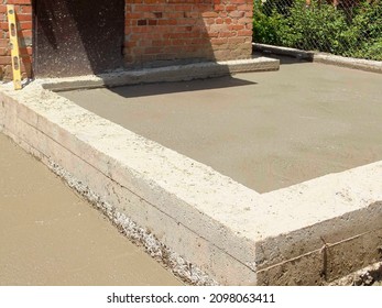 Pouring Concrete Floors Inside Foundation. Construction Of An Extension To One-story Residential Building. Expansion Of Living Area Of Old Country House.