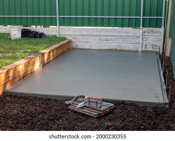 Pouring concrete slab for shed foundation in backyard - Shutterstock ID 2000230355