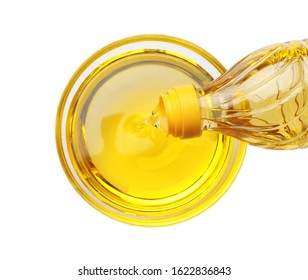 Pouring Cooking Oil From Bottle Into Bowl Isolated On White, Top View