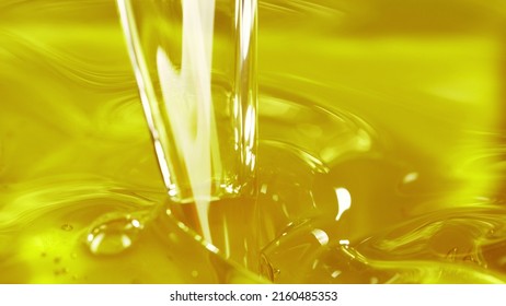 Pouring Cooking Oil, Closeup. Freeze Motion Of Splashing Liquid.