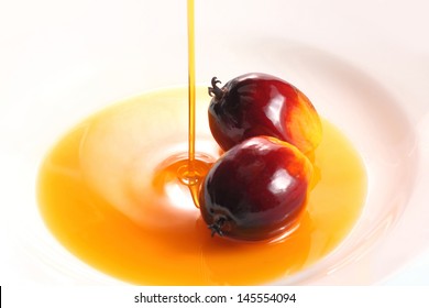 Pouring Cooking Oil On White Background With Oil Palm Fruits