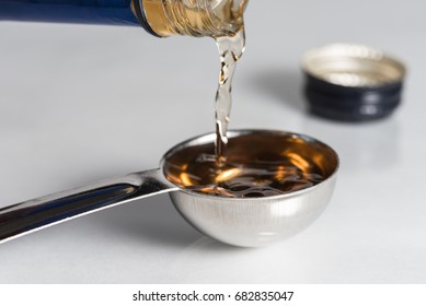 Pouring Cooking Sherry Into A Tablespoon