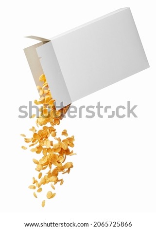 pouring corn flakes from its box isolated on white