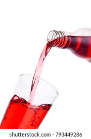 Pouring Cranberry Red Juice From Bottle To Glass  On White Background