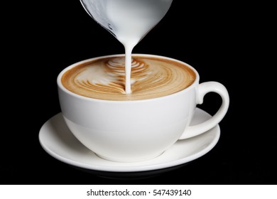 Pouring Cream To Cappuccino. Big White Cup On Black Background.