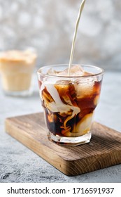 Pouring Cream In Iced Coffee In Rocks Glass