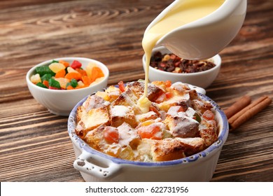 Pouring Custard On Freshly Baked Bread Pudding In Casserole Dish