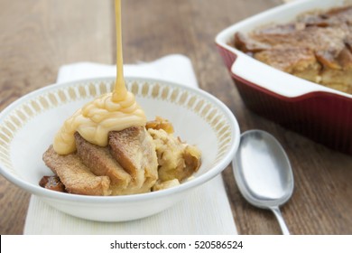 Pouring Custard On A Serving Of Bread And Butter Pudding