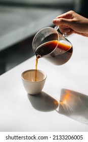 Pouring delicious coffee into a beautiful cup