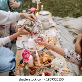 pouring a drink or lemonade into a glass at a picnic party. a transparent bottle of homemade lavender lemonade at outdoor party. - Powered by Shutterstock