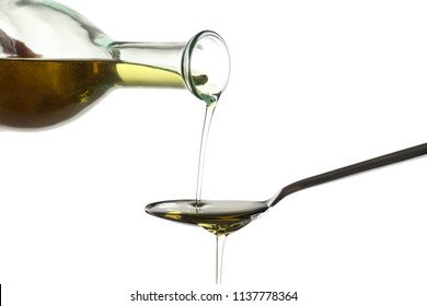 Pouring Fresh Olive Oil Into Spoon On White Background