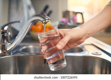 Pouring Fresh Tap Water Into a Glass  - Shutterstock ID 1007226595
