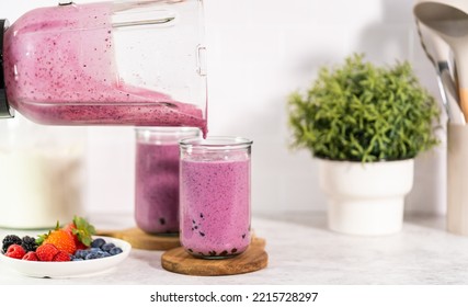 Pouring Freshly Made Mixed Berry Boba Smoothie Into A Drinking Glass.