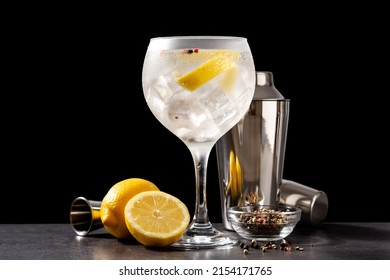 Pouring Gin Tonic Drink Into A Glass On Black Background