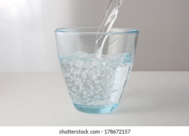 Pouring A Glass Of Carbonated Water