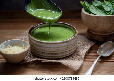 Pouring Green Creamy Spinach Soup Rustic, Lifestyle Food, Delicious Vegan Food