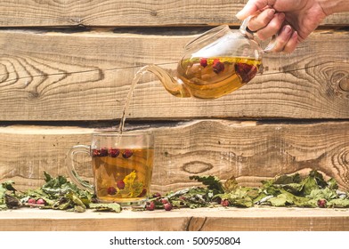 Pouring Herbal Tea On Wooden Boards