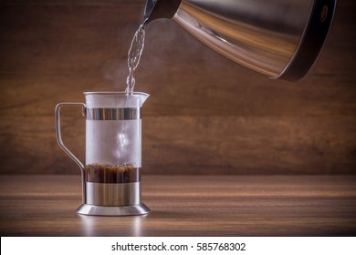 Pouring The Hot Water Into The French Press Glass 