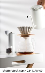 Pouring hot water through coffee grounds in a filter