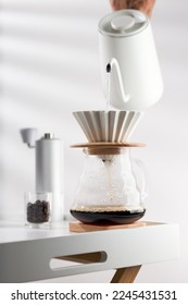 Pouring hot water through coffee grounds in a filter