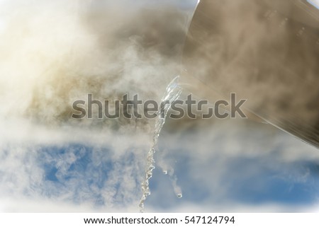Pouring hot water in winter at sunset