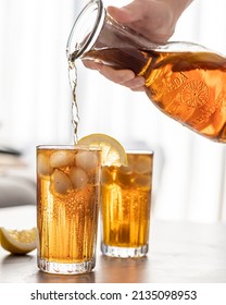 Pouring Iced Tea In A Glass With Ice Cubes