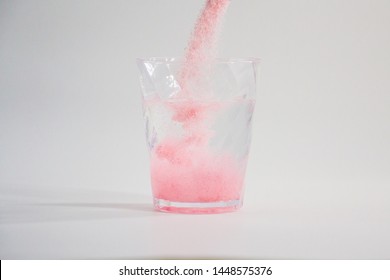 Pouring Instant Drink Pink Colour Powder In Glass Of Water 