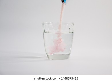 Pouring Instant Drink Purple Colour Powder In Glass Of Water 