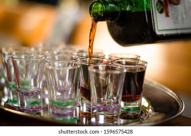 Pouring Jägermeister Into Shot Glasses