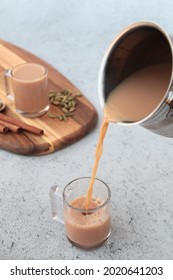 Pouring Karak Tea From A Pot Into A Cup