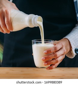 Pouring Kefir Into Glass, A Healthy Fermented Dairy Superfood Drink, Rich In Natural Probiotics Lacto And Bifido Bacterium