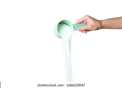Pouring laundry detergent from measuring container against WHite background, closeup. There is a space for the text - Shutterstock ID 1686233047