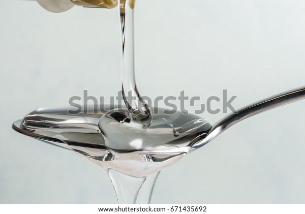 Pouring Light Corn Syrup on a\
Spoon